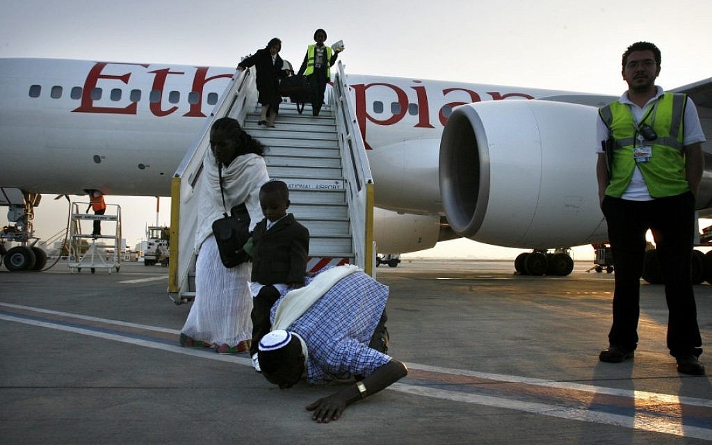 A Falash Mura man kisses the ground as the flight from Ethiopia lands at the airport in Israel in May 2008 (photo credit: Michal Fattal/Flash90)