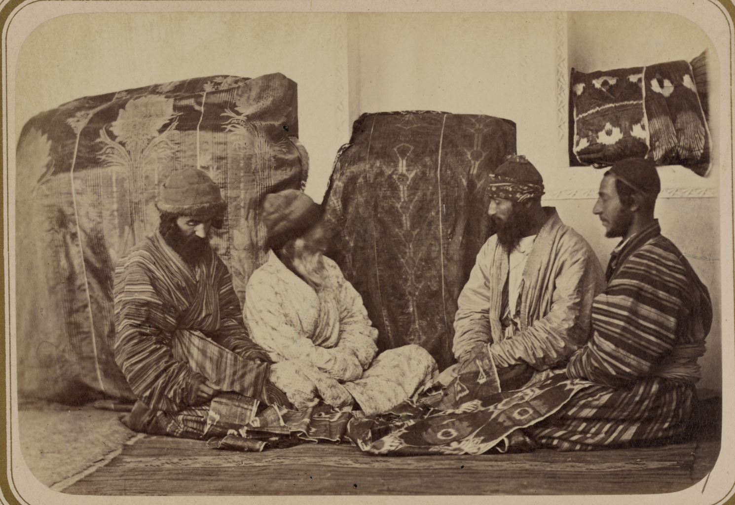 Four Jewish Men Seated on the Ground next to Two Large Covered Bundles, Inspecting the Dowry